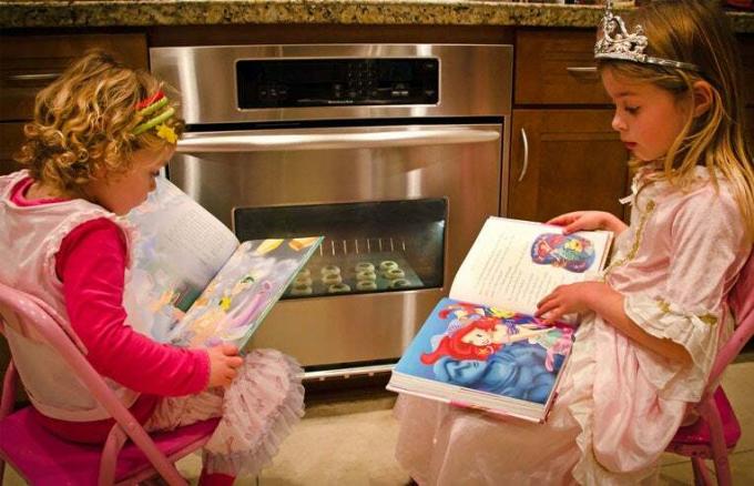 فتيات يقرأن بينما يرتدين زي الأميرات
