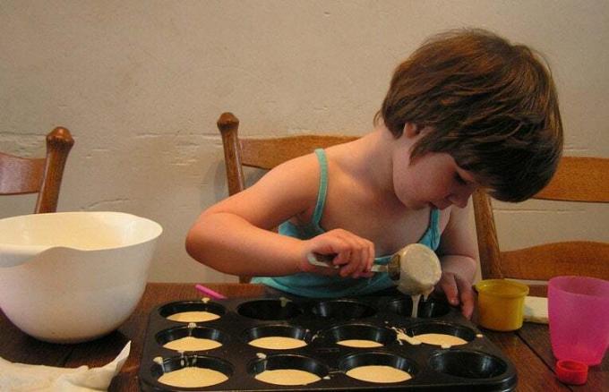 ילדה מכינה קאפקייקס